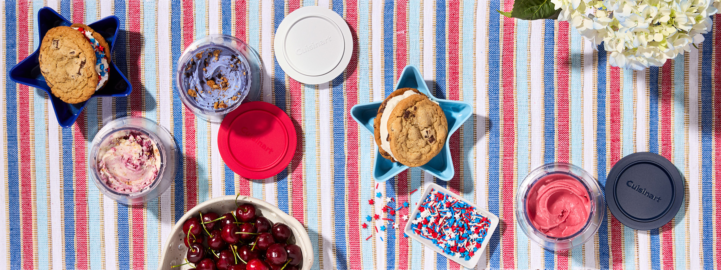 ice cream and ice cream sandwiches with fruit and sprinkles.